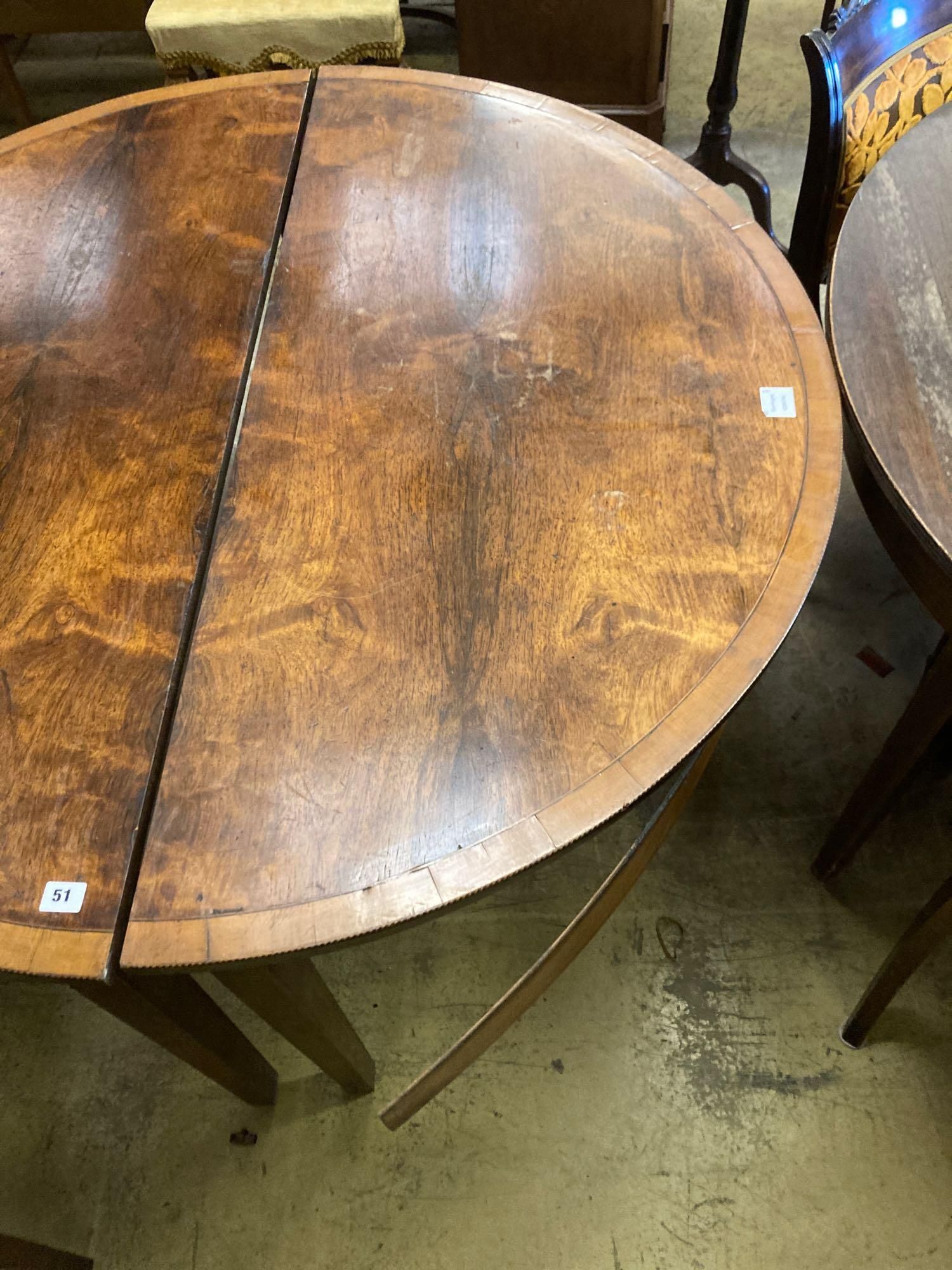 A pair of George III satinwood banded mahogany demi lune dining table ends, width 123cm height 74cm